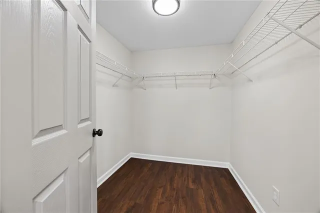 a view of a room with wooden floor