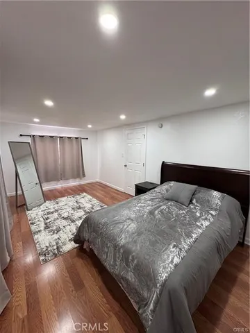 a large bed sitting in a room next to a lamp