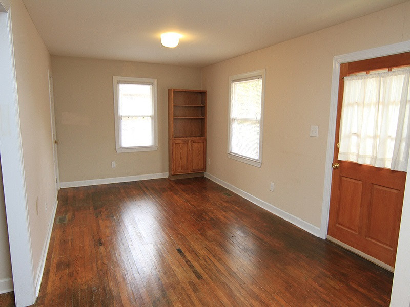 1027 Carpenter Fletcher Road Durham, NC 27713 - Photo 4 of 12 Living room has original hardwood floors, as does the entire home with the exception of bathroom. Built-in bookshelves. Living Room