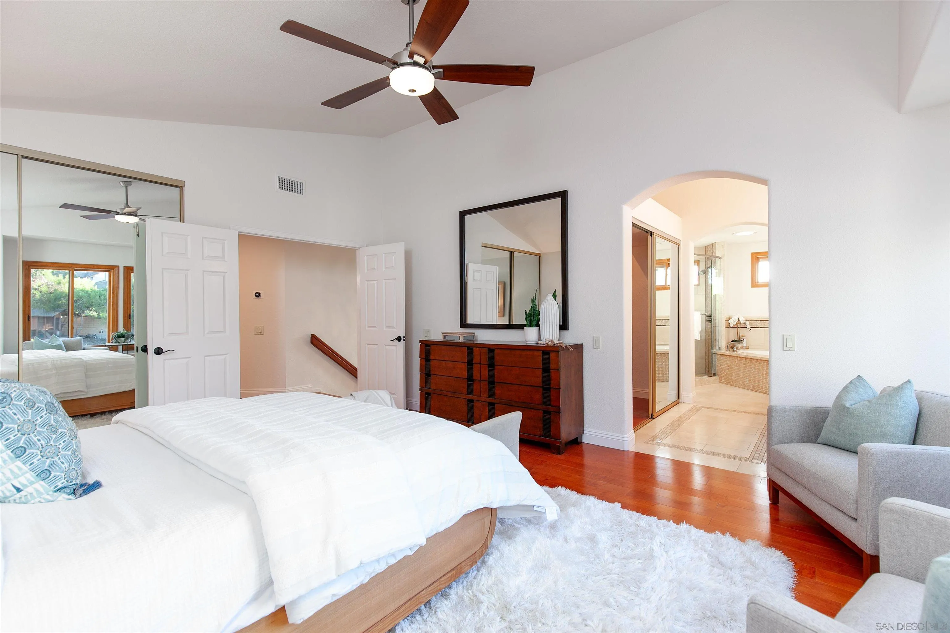 3245 Lower Ridge Road San Diego, CA 92130 - Photo 12 of 45 a bedroom with a large bed a chandelier and dresser