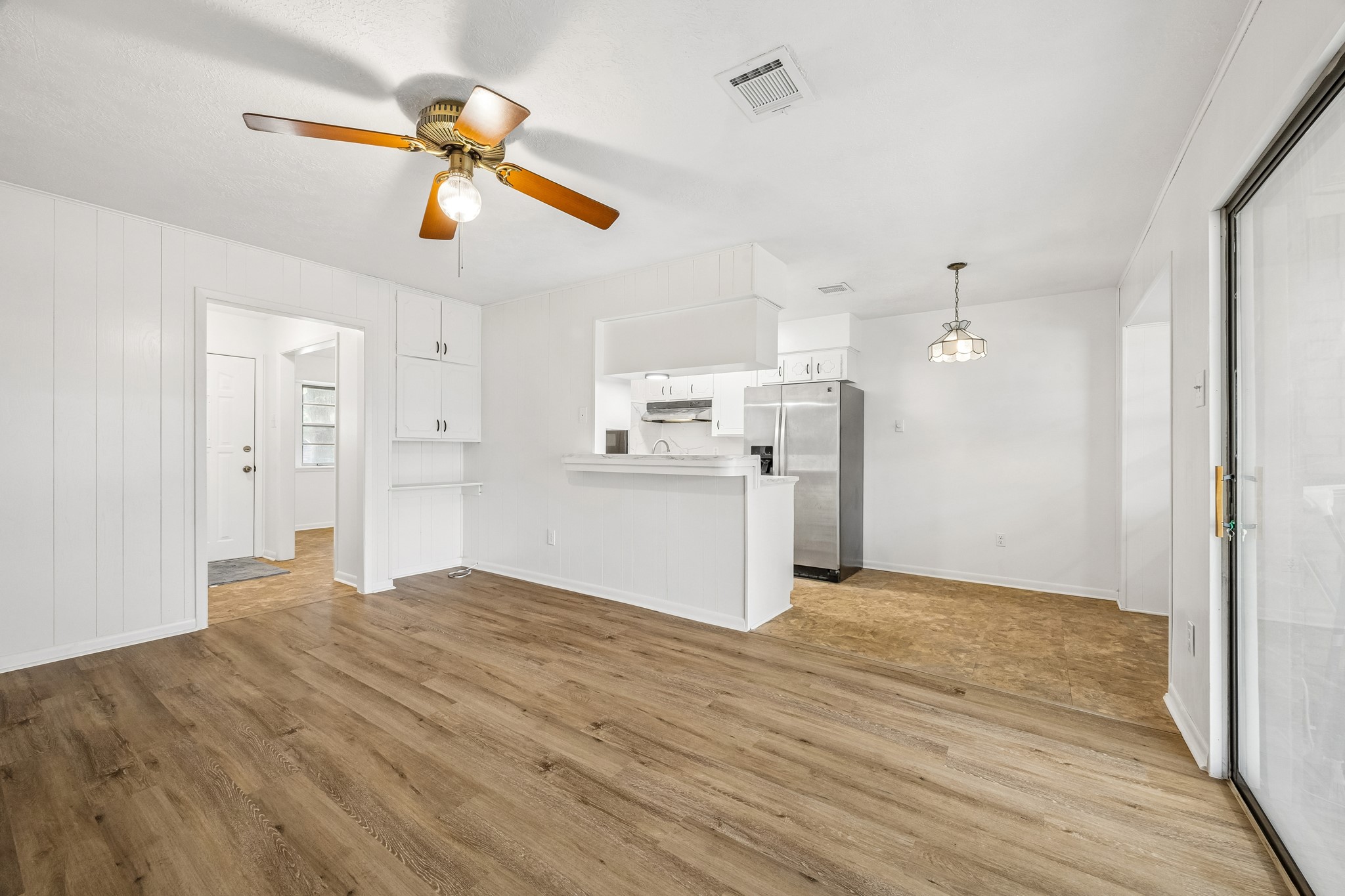 4903 Mistletoe Road Pasadena, TX 77505 - Photo 2 of 10 a view of a kitchen with a refrigerator and a ceiling fan