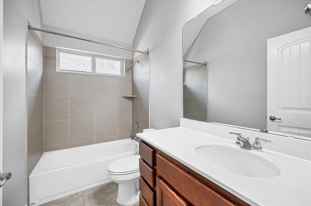 1909 Goldilocks Lane Manchaca, TX 78652 - Photo 12 of 27 a bathroom with a sink a toilet and shower