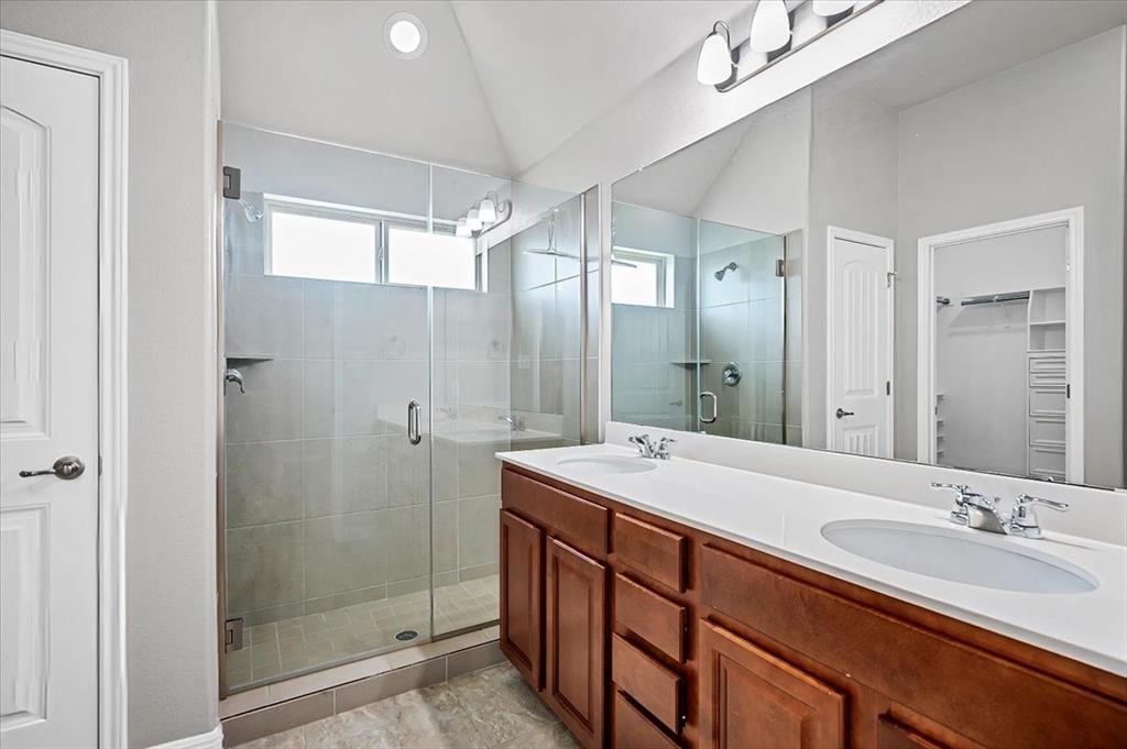 1909 Goldilocks Lane Manchaca, TX 78652 - Photo 14 of 27 a bathroom with a double vanity sink mirror and shower