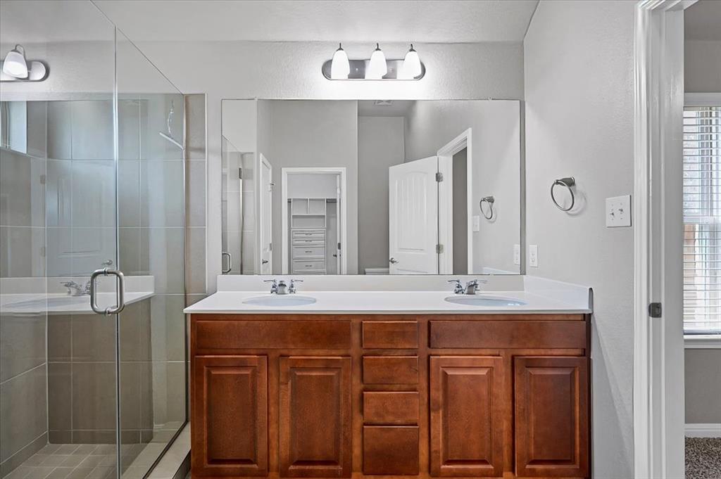 1909 Goldilocks Lane Manchaca, TX 78652 - Photo 15 of 27 a bathroom with a sink and a mirror