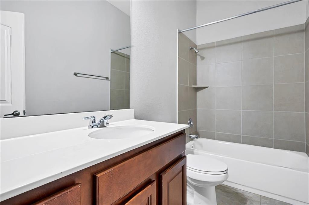 1909 Goldilocks Lane Manchaca, TX 78652 - Photo 21 of 27 a bathroom with a sink a toilet and shower