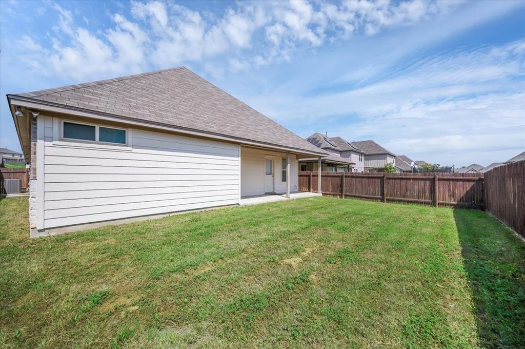 1909 Goldilocks Lane Manchaca, TX 78652 - Photo 24 of 27 a view of a backyard with plants and large trees