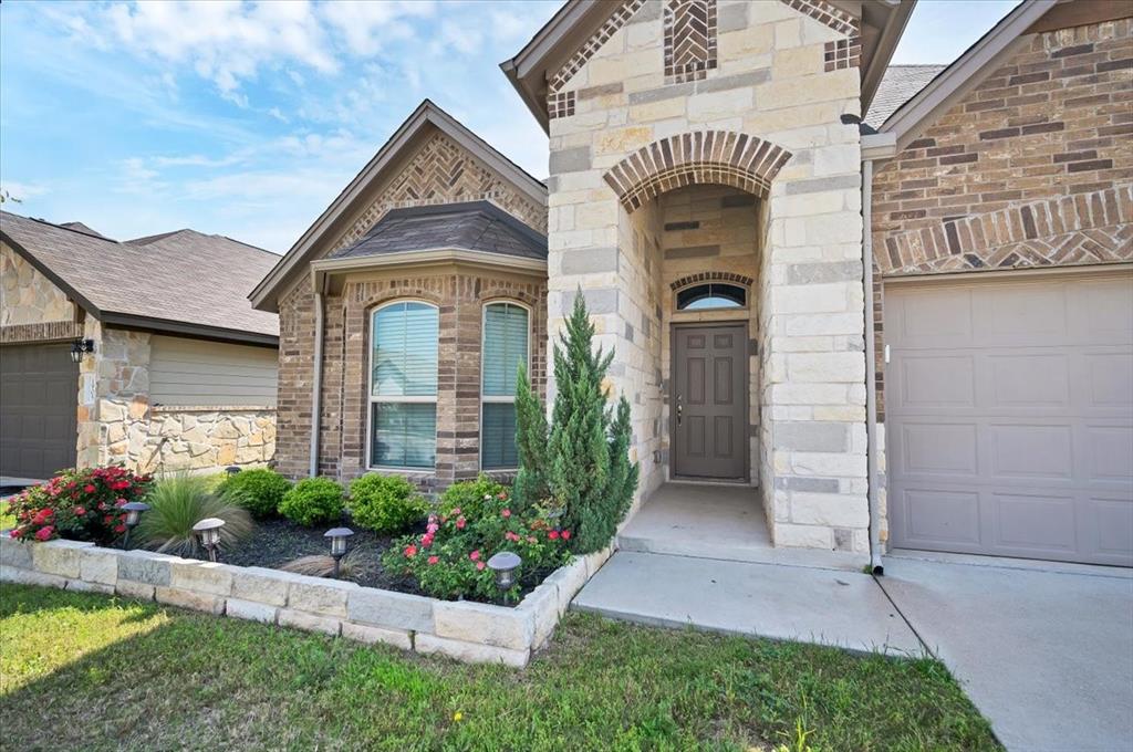 1909 Goldilocks Lane Manchaca, TX 78652 - Photo 3 of 27 a front view of a house with a yard