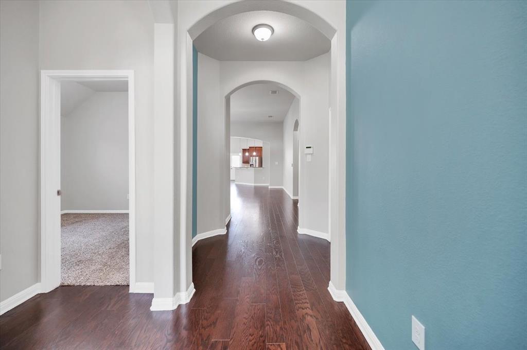 1909 Goldilocks Lane Manchaca, TX 78652 - Photo 4 of 27 a view of a hallway with wooden floor