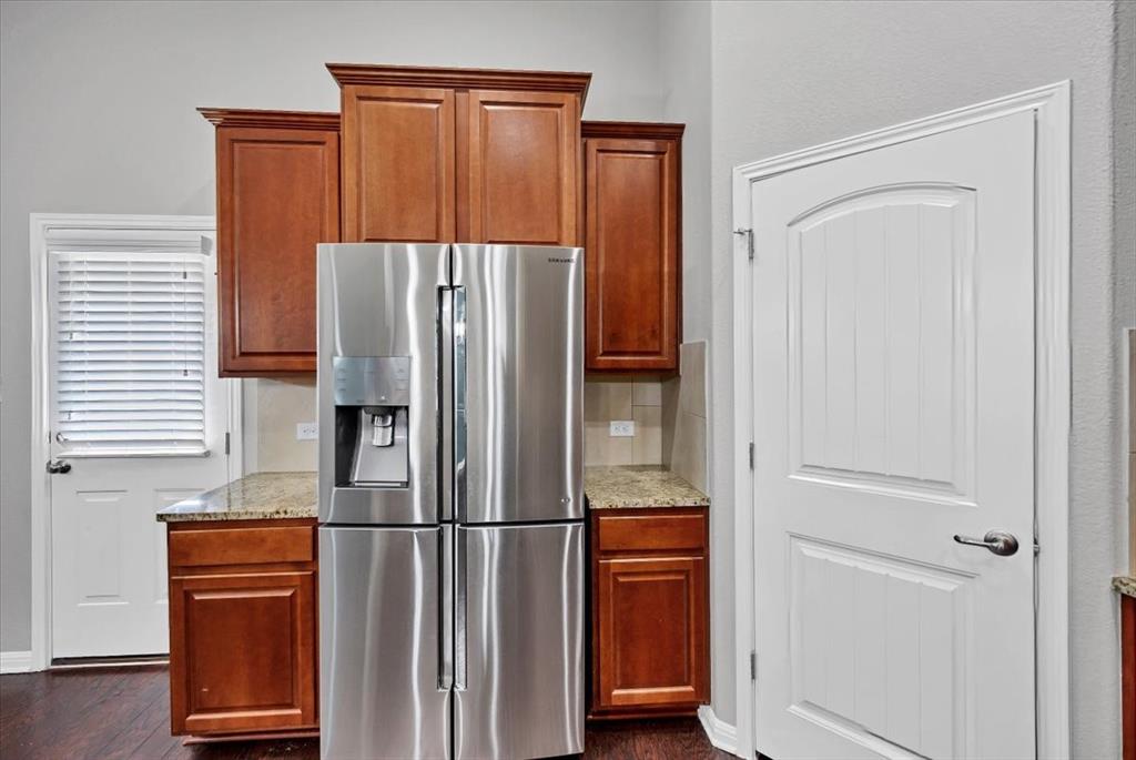 1909 Goldilocks Lane Manchaca, TX 78652 - Photo 9 of 27 a metallic refrigerator freezer sitting in a kitchen
