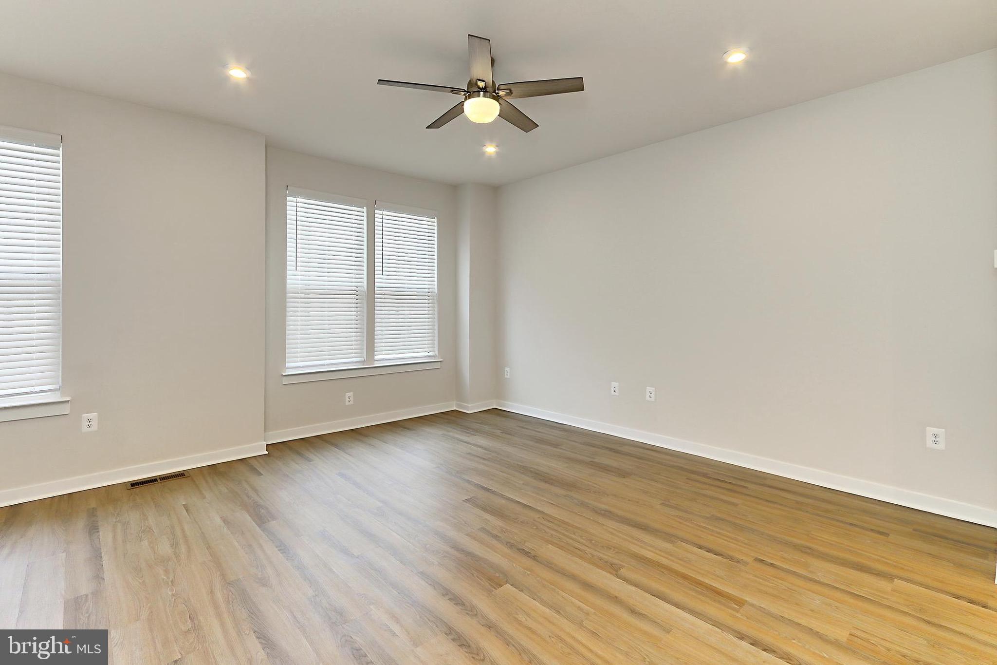 14176 Gypsum Loop Chantilly, VA 20151 - Photo 13 of 44 an empty room with wooden floor and windows