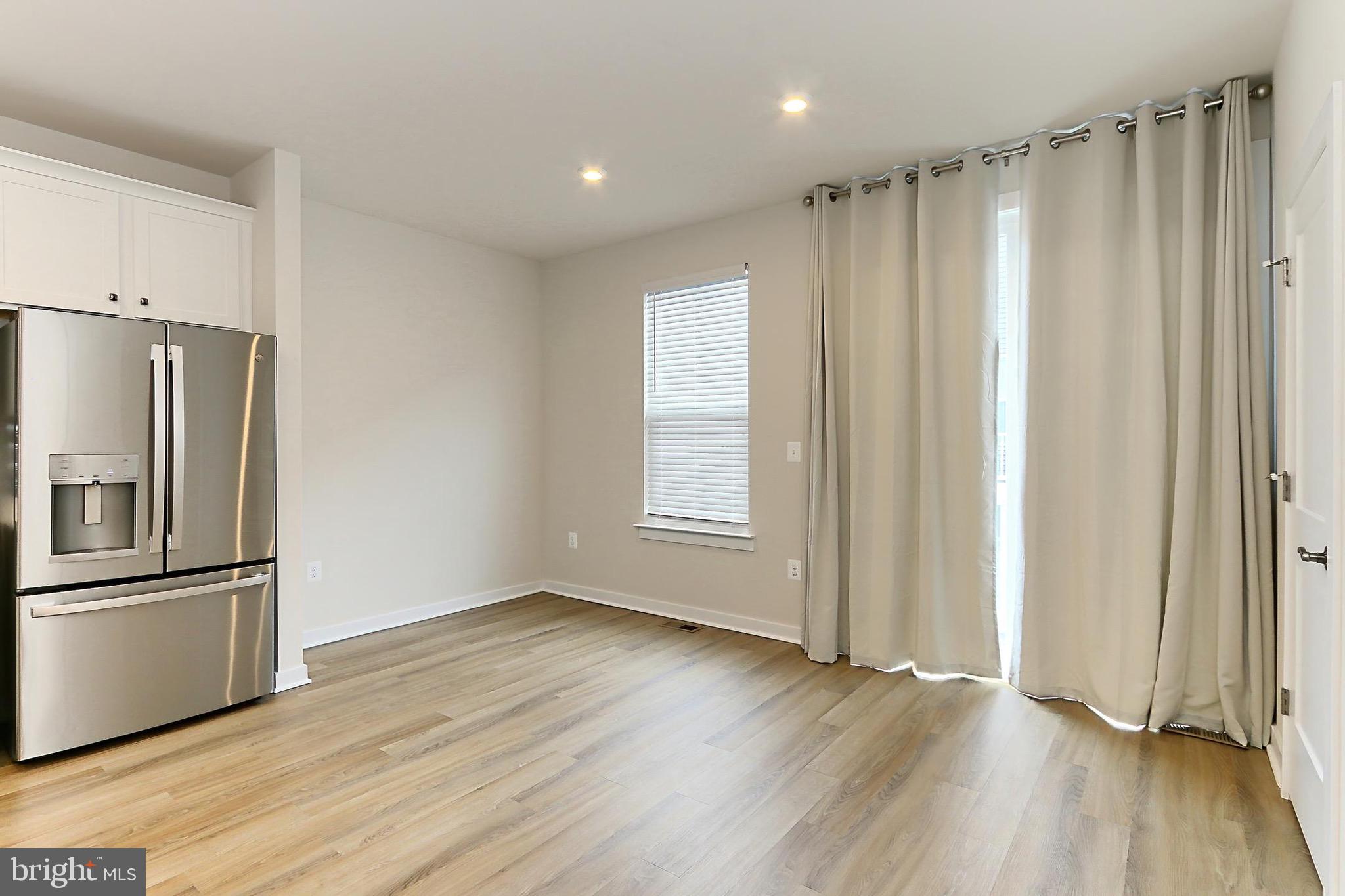 14176 Gypsum Loop Chantilly, VA 20151 - Photo 17 of 44 a view of a kitchen with wooden floor electronic appliances and windows