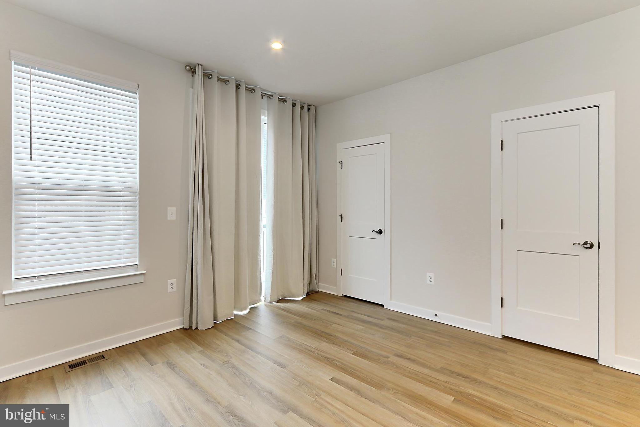 14176 Gypsum Loop Chantilly, VA 20151 - Photo 19 of 44 an empty room with wooden floor and windows