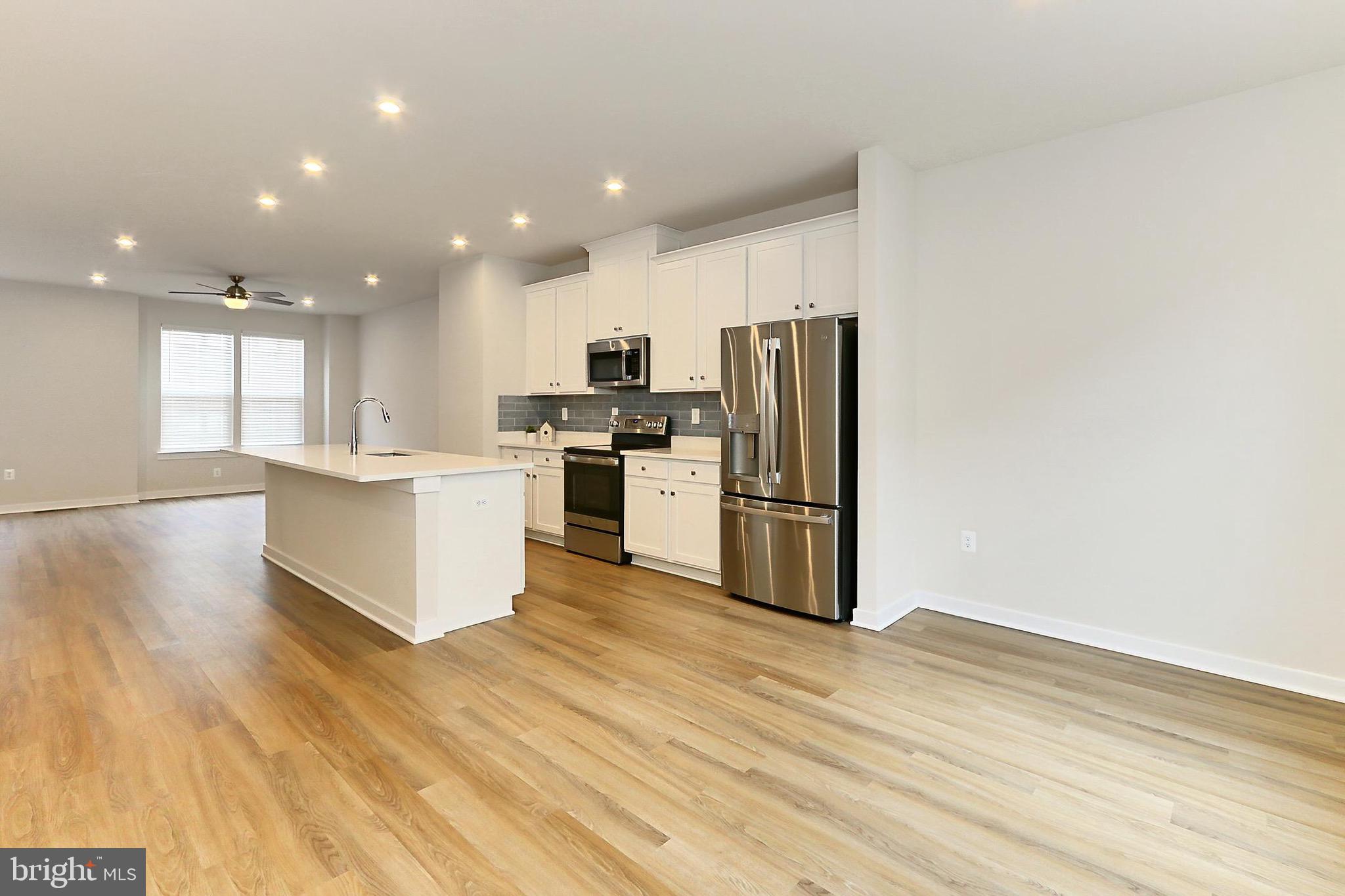 14176 Gypsum Loop Chantilly, VA 20151 - Photo 21 of 44 a kitchen with a refrigerator and a stove top oven