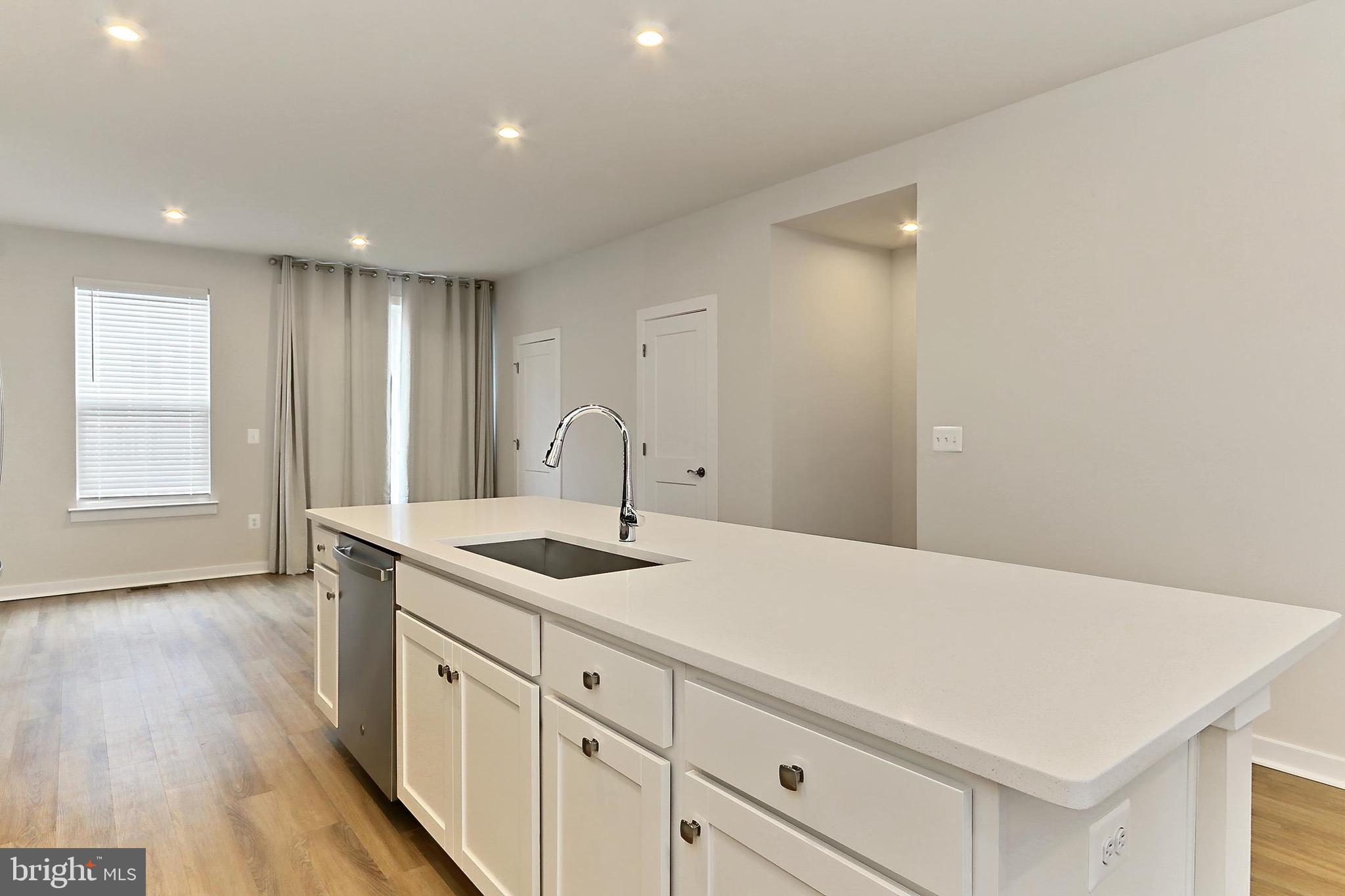 14176 Gypsum Loop Chantilly, VA 20151 - Photo 25 of 44 a kitchen with a sink and wooden floor
