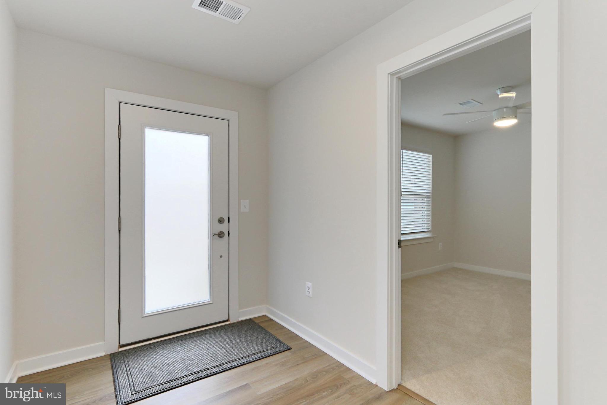 14176 Gypsum Loop Chantilly, VA 20151 - Photo 3 of 44 an empty room with mirror and a hallway