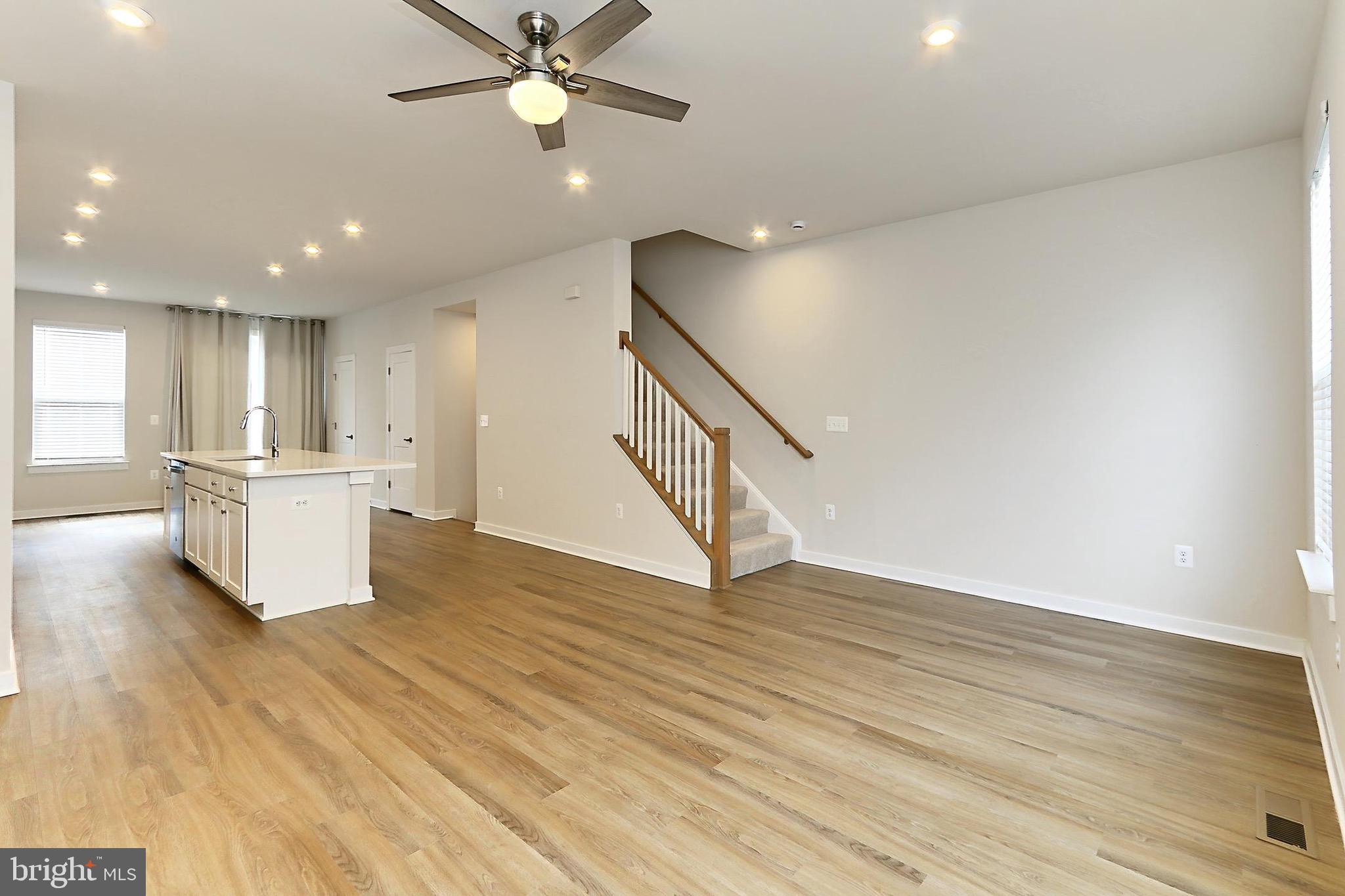 14176 Gypsum Loop Chantilly, VA 20151 - Photo 6 of 44 a view of a kitchen with wooden floor and a ceiling fan