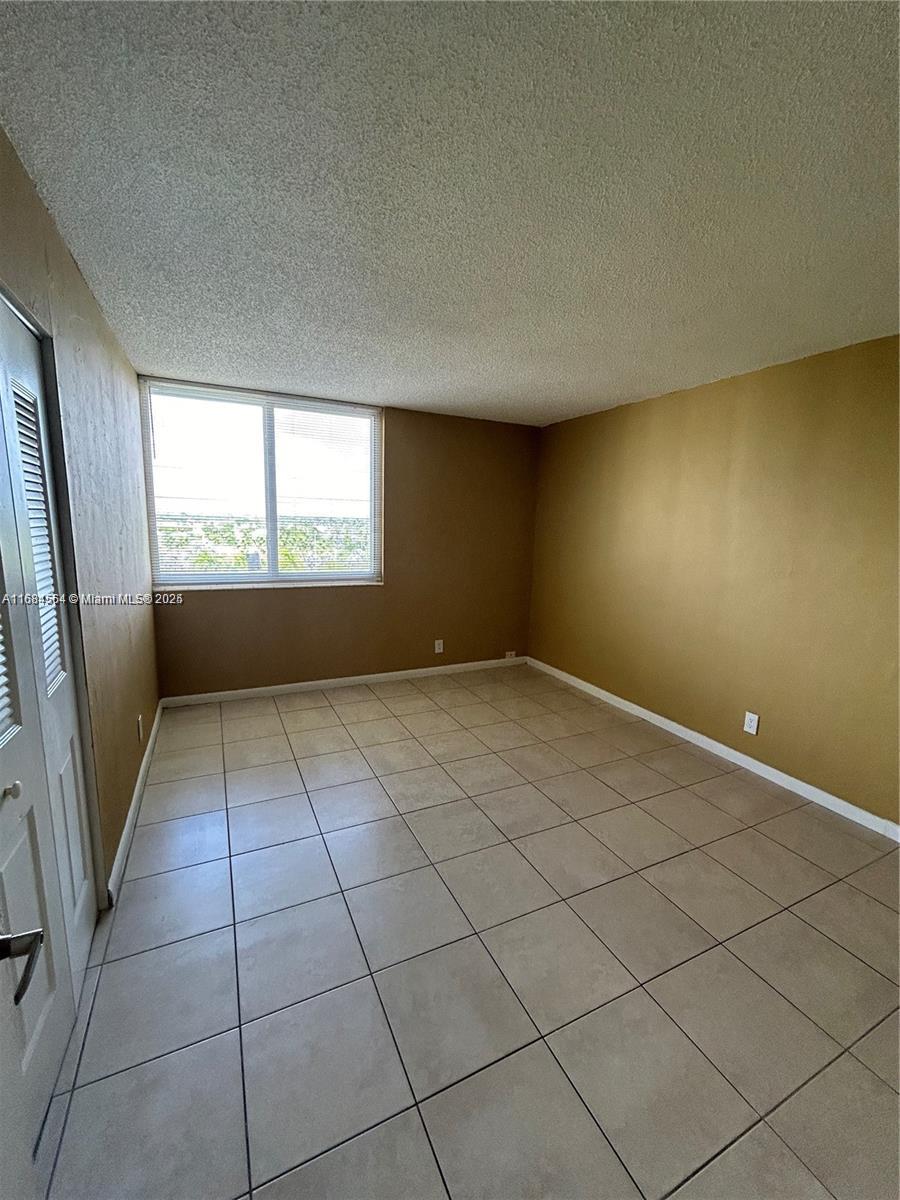 9143 Southwest 77th Avenue, Unit B802 Miami, FL 33156 - Photo 11 of 12 an empty room with windows