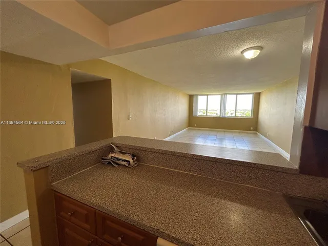a room with pool table and windows
