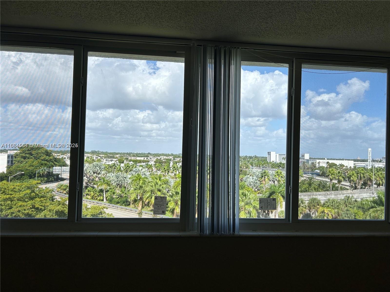 9143 Southwest 77th Avenue, Unit B802 Miami, FL 33156 - Photo 4 of 12 a view of a room that has a large window