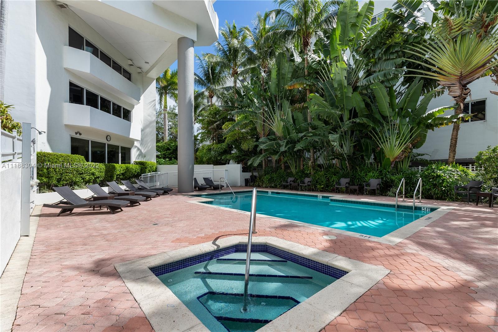 1621 Bay Road, Unit 602 Miami Beach, FL 33139 - Photo 15 of 28 a swimming pool with outdoor seating and yard