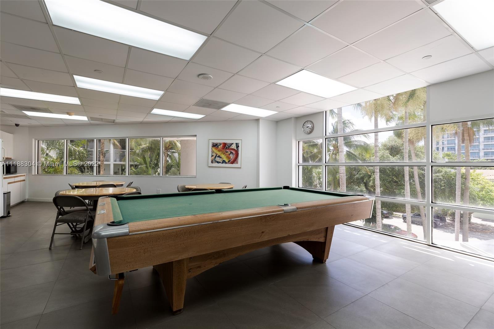 1621 Bay Road, Unit 602 Miami Beach, FL 33139 - Photo 16 of 28 a room with pool table and windows