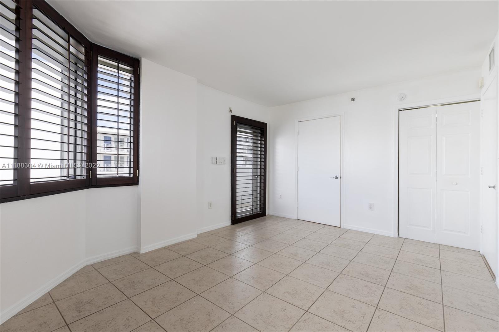 1621 Bay Road, Unit 602 Miami Beach, FL 33139 - Photo 27 of 28 a view of an empty room with window and a kitchen