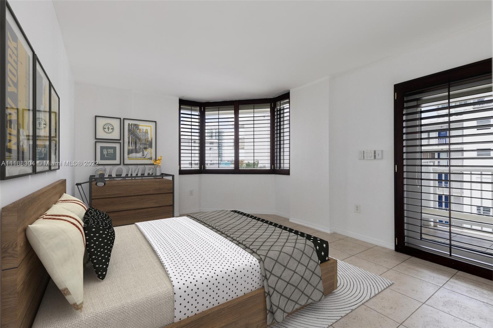 1621 Bay Road, Unit 602 Miami Beach, FL 33139 - Photo 10 of 28 a bedroom with a bed and a couch