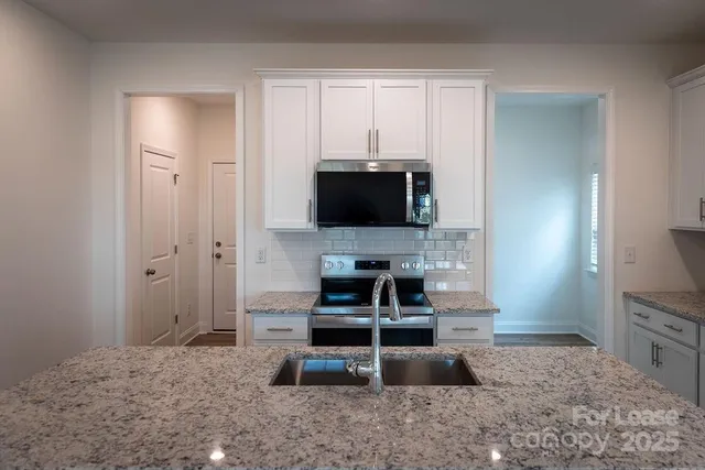 a kitchen with a stove and a sink