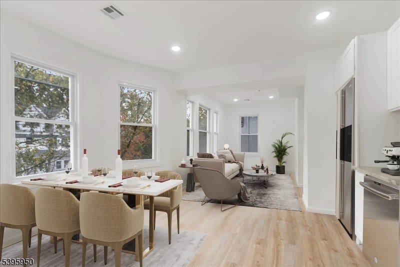 813 South 12th Street Newark, NJ 07108 - Photo 1 of 14 a living room with furniture kitchen view and a large window