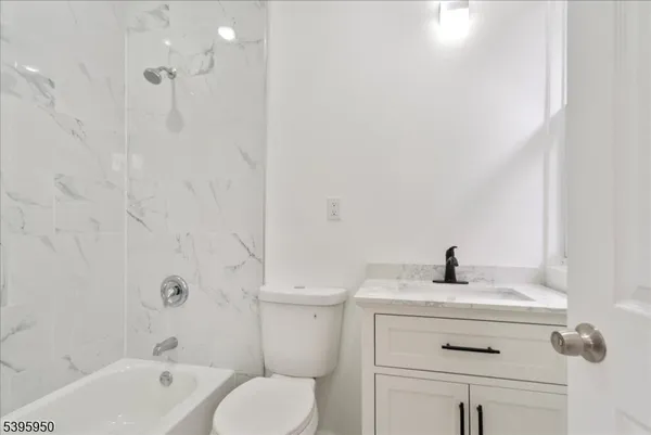 a bathroom with a sink a toilet and a bathtub