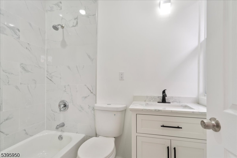 813 South 12th Street Newark, NJ 07108 - Photo 8 of 14 a bathroom with a sink a toilet and a bathtub