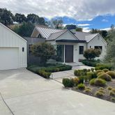 a front view of a house with a garden