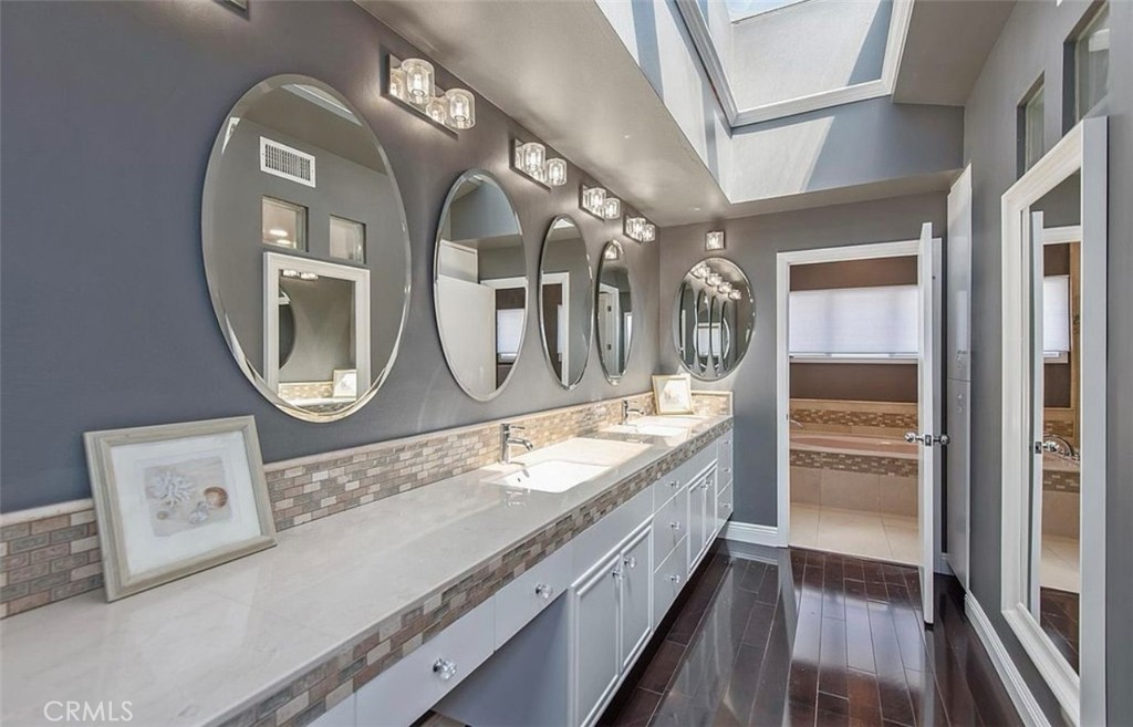 24907 Marbella Court Calabasas, CA 91302 - Photo 22 of 34 a bathroom with a granite countertop double vanity sink and a mirror