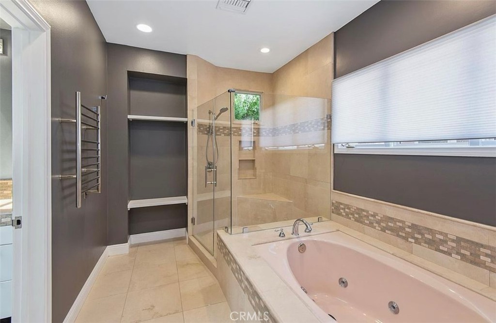 24907 Marbella Court Calabasas, CA 91302 - Photo 23 of 34 a bathroom with a bathtub and a shower