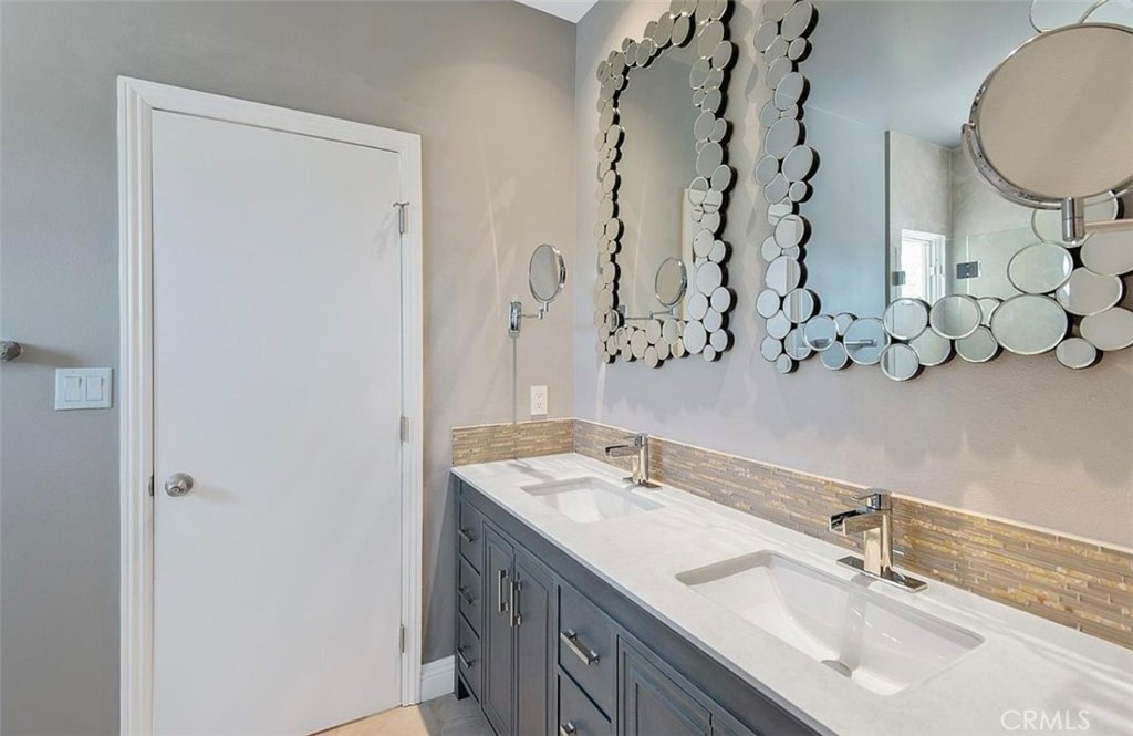 24907 Marbella Court Calabasas, CA 91302 - Photo 29 of 34 a bathroom with a granite countertop sink and a mirror