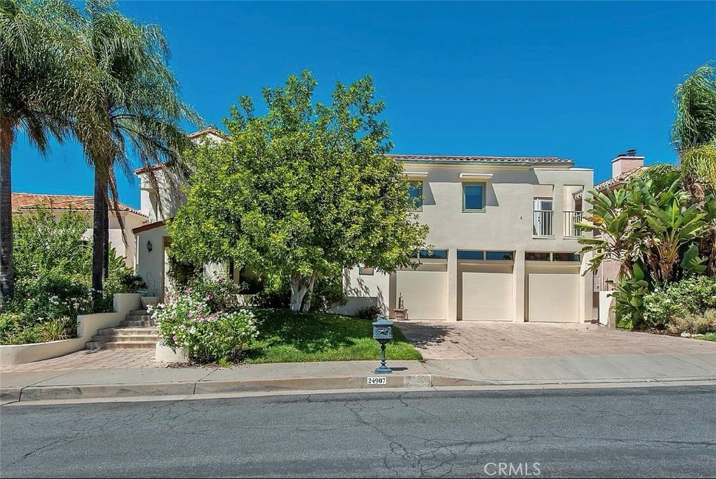 24907 Marbella Court Calabasas, CA 91302 - Photo 3 of 34 a front view of a house with a yard and garage
