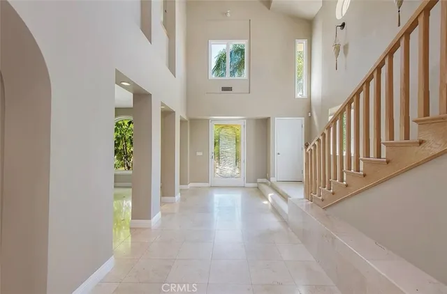 a kitchen with kitchen island granite countertop a sink and a refrigerator