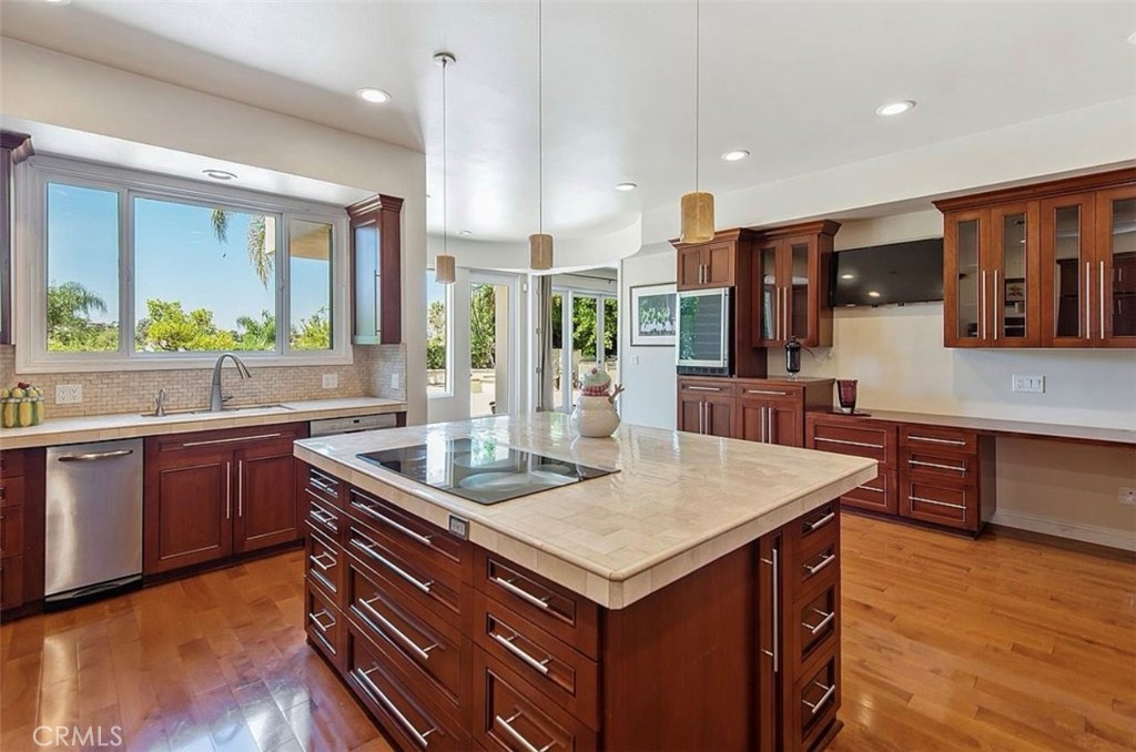 24907 Marbella Court Calabasas, CA 91302 - Photo 9 of 34 a kitchen with stainless steel appliances granite countertop a sink a stove and a wooden floors