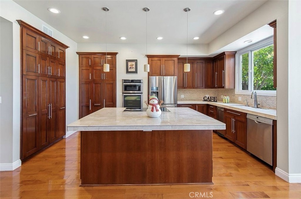 24907 Marbella Court Calabasas, CA 91302 - Photo 10 of 34 a kitchen with stainless steel appliances granite countertop a sink a stove and a refrigerator