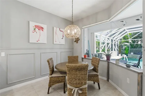 a dining room with furniture a chandelier and window