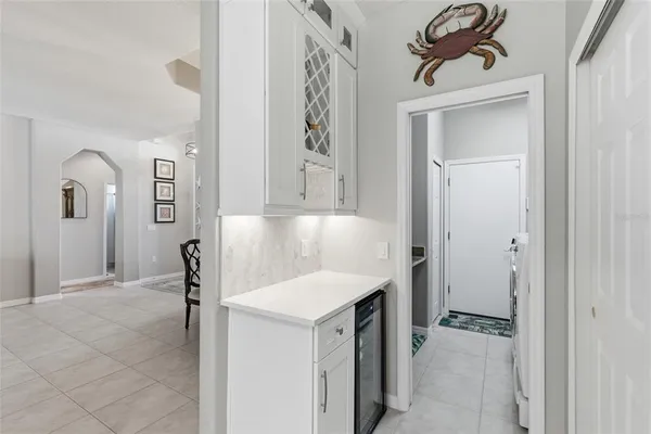 a view of a hallway to a livingroom and a bathroom