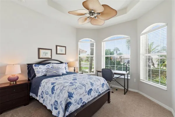 a bedroom with two beds and a large window