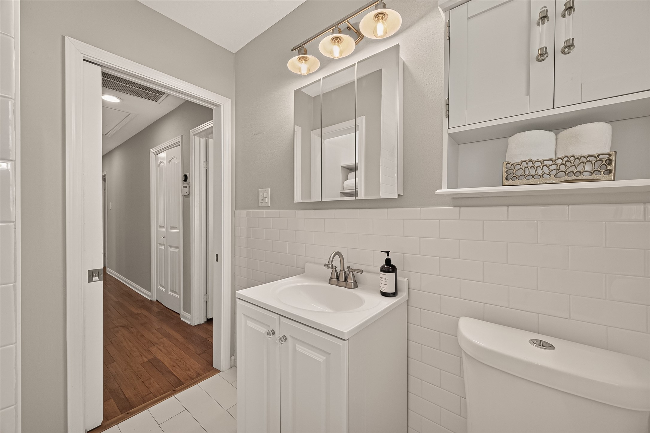 2019 Gostick Street Houston, TX 77008 - Photo 27 of 36 a bathroom with a sink a toilet and a mirror