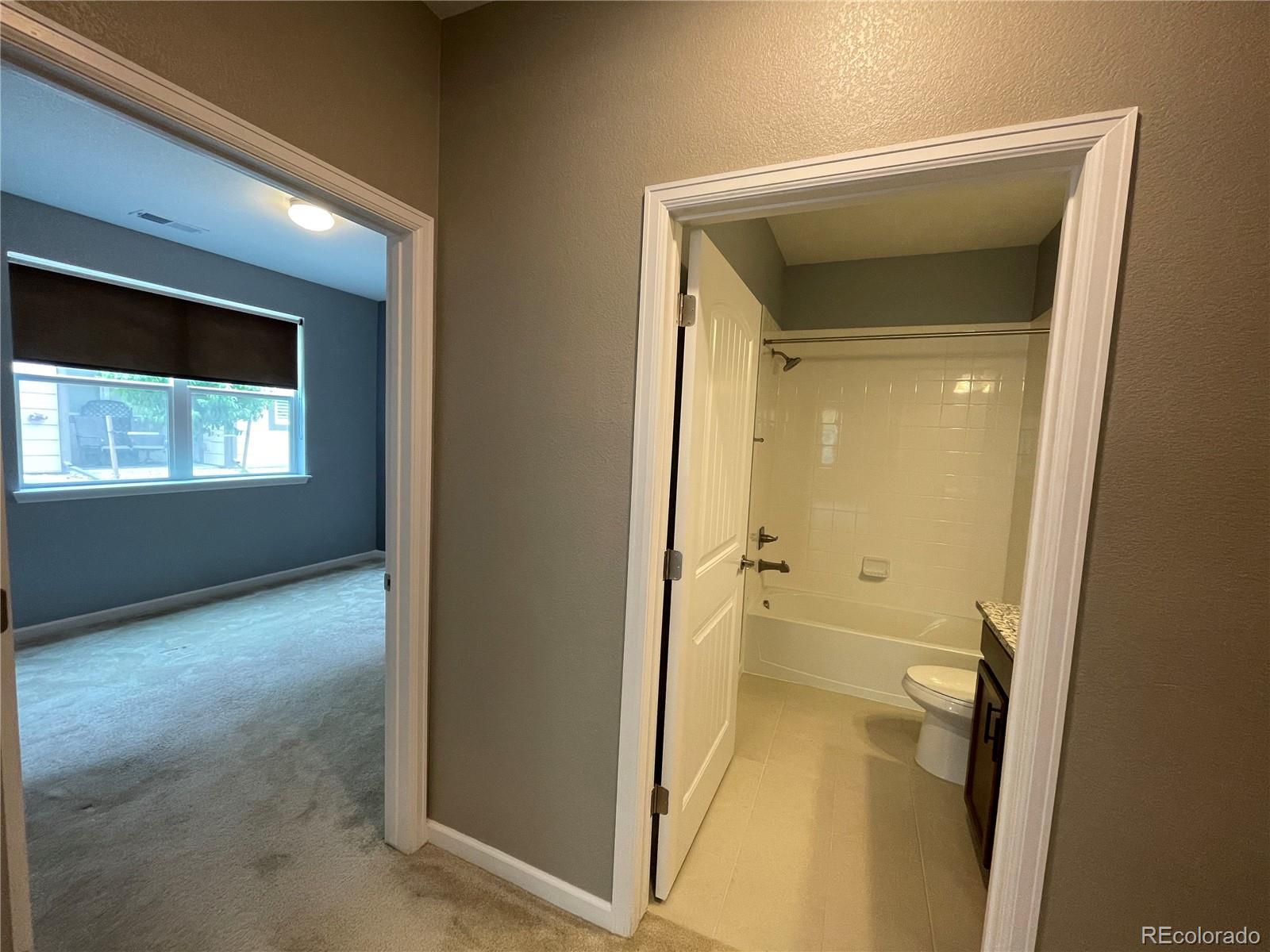 4604 Copeland Circle, Unit 103 Highlands Ranch, CO 80126 - Photo 5 of 11 a view of a hallway with wooden floor and a living room