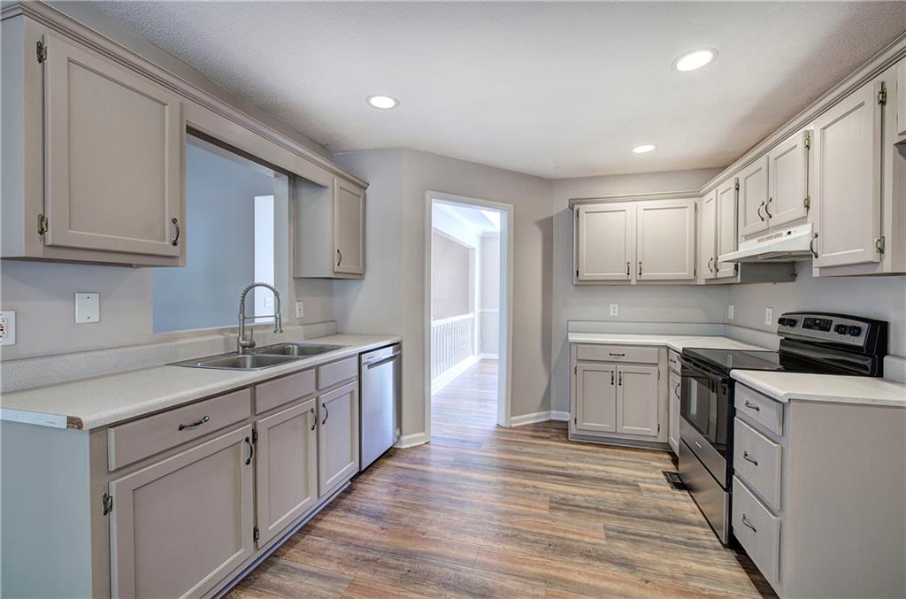 15 Roving Hills Circle Cartersville, GA 30121 - Photo 15 of 55 a kitchen with stainless steel appliances granite countertop a sink stove and refrigerator
