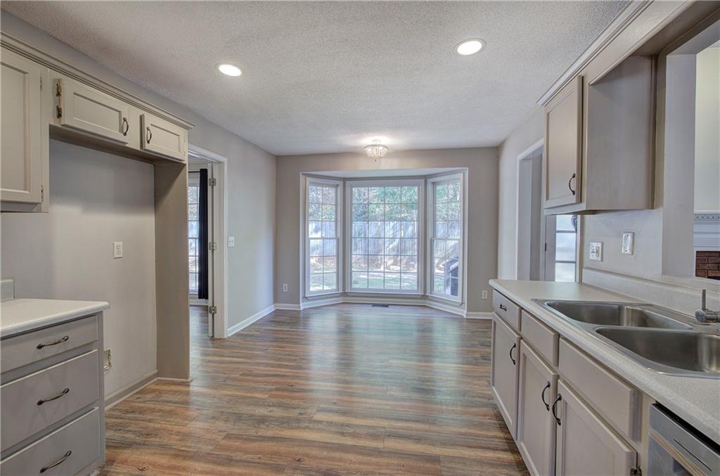 15 Roving Hills Circle Cartersville, GA 30121 - Photo 18 of 55 a kitchen with stainless steel appliances granite countertop a sink stove and refrigerator