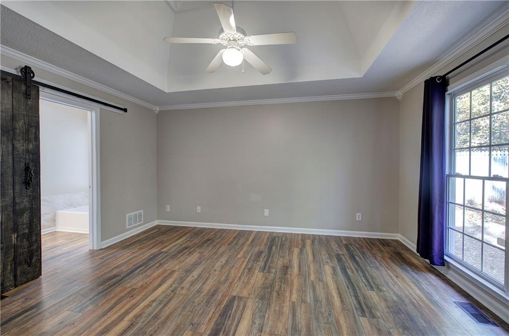15 Roving Hills Circle Cartersville, GA 30121 - Photo 19 of 55 wooden floor in an empty room with a window