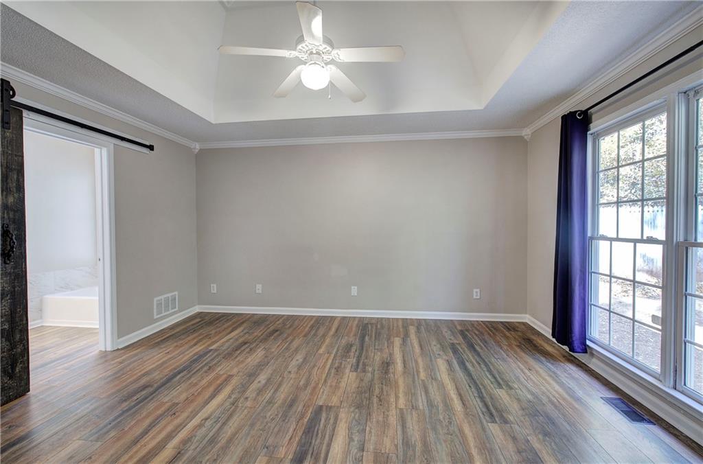 15 Roving Hills Circle Cartersville, GA 30121 - Photo 20 of 55 wooden floor in an empty room with a window