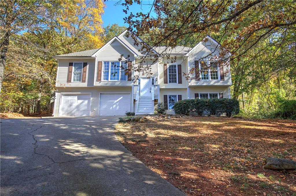 15 Roving Hills Circle Cartersville, GA 30121 - Photo 2 of 55 a front view of a house with a yard and garage