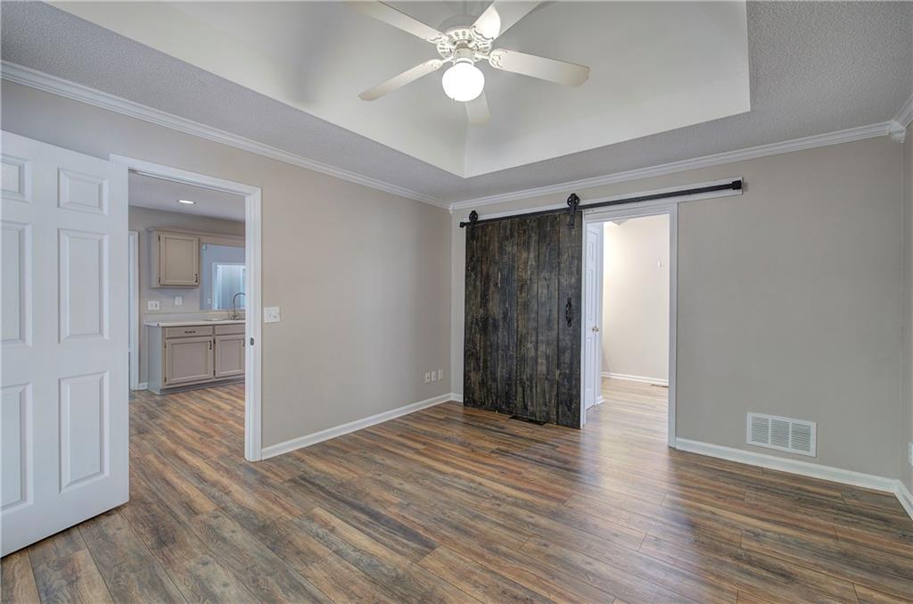 15 Roving Hills Circle Cartersville, GA 30121 - Photo 21 of 55 wooden floor in an empty room with a window